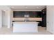 Modern kitchen with island, stainless steel appliances, and dark cabinetry at 10236 E Ursula Ave, Mesa, AZ 85212
