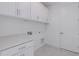 Bright laundry room with white cabinets and countertop at 10236 E Ursula Ave, Mesa, AZ 85212