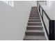 Modern staircase with grey carpet and metal railing at 10236 E Ursula Ave, Mesa, AZ 85212