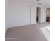 Bright bedroom featuring carpeted floors and access to a bathroom at 10249 E Ulysses Ave, Mesa, AZ 85212