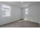 Bright bedroom with neutral carpeting and large windows at 10249 E Ulysses Ave, Mesa, AZ 85212