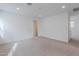 Bright and airy bedroom with neutral carpet and door to hallway at 10249 E Ulysses Ave, Mesa, AZ 85212