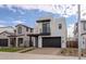 Contemporary two-story house with a dark garage door and walkway at 10249 E Ulysses Ave, Mesa, AZ 85212