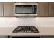 Stainless steel microwave above gas cooktop at 10249 E Ulysses Ave, Mesa, AZ 85212