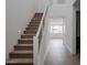 Modern staircase with neutral carpeting and metal railing at 10249 E Ulysses Ave, Mesa, AZ 85212