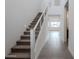 Modern staircase with metal railing leading to the second floor at 10249 E Ulysses Ave, Mesa, AZ 85212