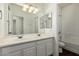 Bathroom with double sinks and a shower/tub combo at 10310 E Posada Ave, Mesa, AZ 85212