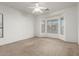 Bright bedroom with neutral walls and carpet, featuring a bay window and ceiling fan at 10310 E Posada Ave, Mesa, AZ 85212