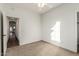 Well-lit bedroom with carpet flooring and access to hallway at 10310 E Posada Ave, Mesa, AZ 85212
