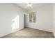 Bright bedroom featuring a window, ceiling fan, and access to hallway at 10310 E Posada Ave, Mesa, AZ 85212