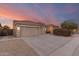 Two-story house with a three car garage and desert landscaping at 10310 E Posada Ave, Mesa, AZ 85212