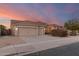 Two-story house with a three car garage and desert landscaping at 10310 E Posada Ave, Mesa, AZ 85212