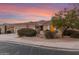 House with a three-car garage and mature desert landscaping at 10310 E Posada Ave, Mesa, AZ 85212