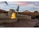 Charming outdoor fireplace with seating area and flagstone patio at 10310 E Posada Ave, Mesa, AZ 85212