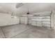 Two-car garage with painted floor and automatic garage door at 10310 E Posada Ave, Mesa, AZ 85212