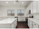 Modern kitchen with white cabinets and an island at 10310 E Posada Ave, Mesa, AZ 85212