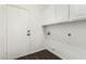Laundry room with white cabinets and built-in shelving at 10310 E Posada Ave, Mesa, AZ 85212
