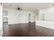 Open living room with dark laminate flooring and ceiling fan at 10310 E Posada Ave, Mesa, AZ 85212