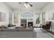 Bright living room with fireplace and large windows at 10310 E Posada Ave, Mesa, AZ 85212