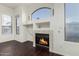 Living room with fireplace and dark laminate flooring at 10310 E Posada Ave, Mesa, AZ 85212