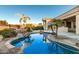 Stunning kidney-shaped pool surrounded by lush landscaping at 10310 E Posada Ave, Mesa, AZ 85212