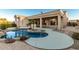 Inviting pool area with a large patio, landscaping, and a built-in barbecue at 10310 E Posada Ave, Mesa, AZ 85212