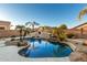 Inviting kidney-shaped pool with a built-in fire pit at 10310 E Posada Ave, Mesa, AZ 85212