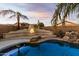 Lovely pool and spa with an outdoor fireplace and seating area at 10310 E Posada Ave, Mesa, AZ 85212