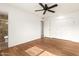 Bright bedroom with wood-look floors, ceiling fan, and en-suite bathroom at 10343 W Prairie Hills Cir, Sun City, AZ 85351