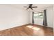 Spacious bedroom with wood-look flooring, ceiling fan and large window at 10343 W Prairie Hills Cir, Sun City, AZ 85351