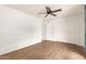 Spacious bedroom with wood-look floors, ceiling fan and double door closet at 10343 W Prairie Hills Cir, Sun City, AZ 85351