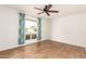 Bedroom features wood-look floors, a ceiling fan, and window with curtains at 10343 W Prairie Hills Cir, Sun City, AZ 85351