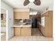 Galley style kitchen with wood cabinets and appliances at 10343 W Prairie Hills Cir, Sun City, AZ 85351