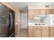 Kitchen boasts ample counter space, wood cabinets, and a door leading to exterior at 10343 W Prairie Hills Cir, Sun City, AZ 85351