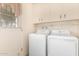 Bright laundry room, washer and dryer included, offers ample storage at 10343 W Prairie Hills Cir, Sun City, AZ 85351