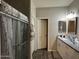 Bathroom with granite vanity, shower, and neutral tile flooring at 12649 W Cabrillo Dr, Arizona City, AZ 85123