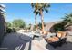 Backyard with spa, seating, and lush landscaping at 15938 W Summerwalk Dr, Surprise, AZ 85374