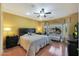 Main bedroom with a king-size bed and wood floors at 15938 W Summerwalk Dr, Surprise, AZ 85374