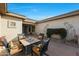 Charming courtyard with seating area and southwestern art at 15938 W Summerwalk Dr, Surprise, AZ 85374