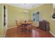 Well-lit dining room featuring hardwood floors and a chandelier at 15938 W Summerwalk Dr, Surprise, AZ 85374