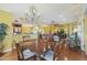 Formal dining room with a chandelier and wood table at 15938 W Summerwalk Dr, Surprise, AZ 85374