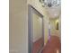 Bright hallway with hardwood floors and large ornate mirror at 15938 W Summerwalk Dr, Surprise, AZ 85374