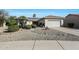 House exterior with two car garage and desert landscaping at 15938 W Summerwalk Dr, Surprise, AZ 85374