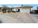 House exterior with two car garage and desert landscaping at 15938 W Summerwalk Dr, Surprise, AZ 85374