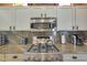 Stainless steel appliances and granite countertops in kitchen at 15938 W Summerwalk Dr, Surprise, AZ 85374