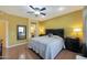Main bedroom with ceiling fan and en-suite bathroom access at 15938 W Summerwalk Dr, Surprise, AZ 85374