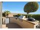 Outdoor kitchen with grill, mini-fridge, and ample counter space at 15938 W Summerwalk Dr, Surprise, AZ 85374