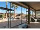 Relaxing screened patio with comfortable seating and a spa at 15938 W Summerwalk Dr, Surprise, AZ 85374