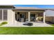 Relaxing backyard with covered patio, fire pit, and artificial turf at 16925 W Virginia Ave, Goodyear, AZ 85395