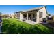 Artificial turf backyard with a covered patio and fire pit at 16925 W Virginia Ave, Goodyear, AZ 85395